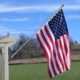 A flag is flying on the side of a house.