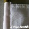 A white cloth with a yellow handle on it.
