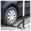 A car parked in the parking lot with its tire on it.