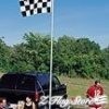 A man standing next to a truck with a checkered flag on it.