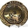 A gold medal with the word korea written on it.