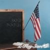 A chalkboard with an american flag and books on it.
