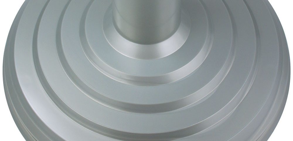 A silver metal object with a hole in the middle.