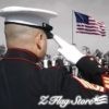 A man in uniform saluting an american flag.