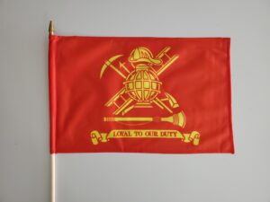 A red flag with gold lettering and a yellow fire department logo.